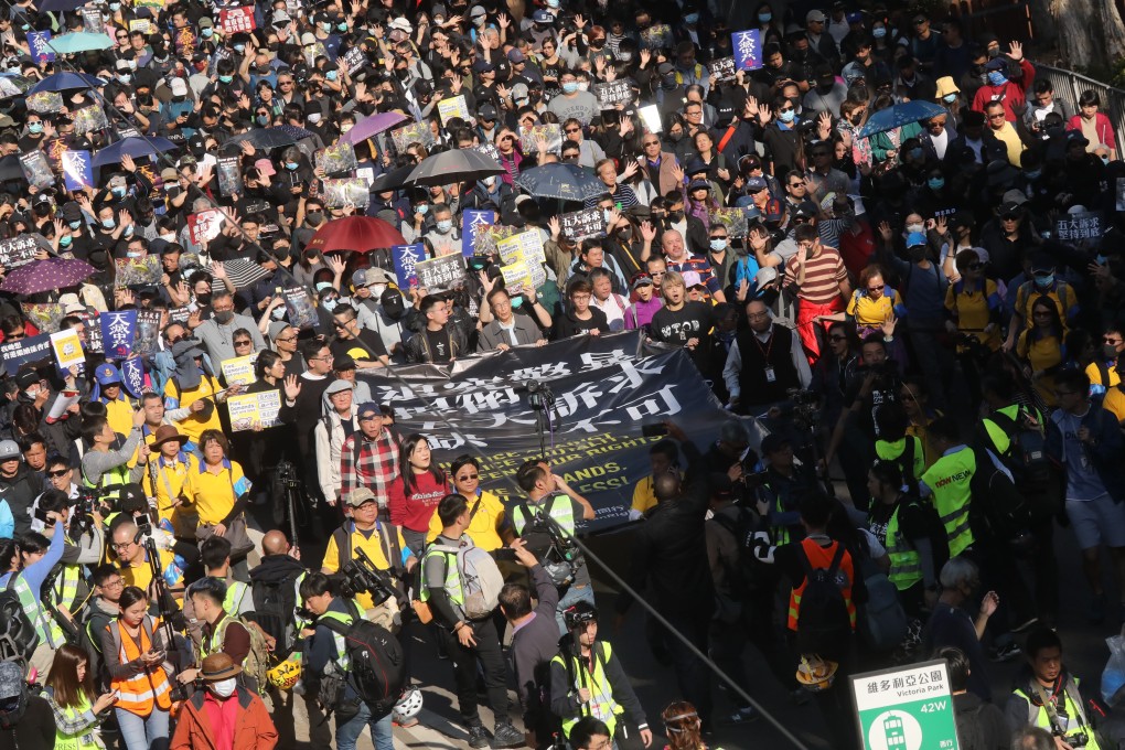 Anti-government protesters march from Causeway Bay to Central on the eve of the six-month anniversary of the unrest on Sunday. Photo: K.Y. Cheng