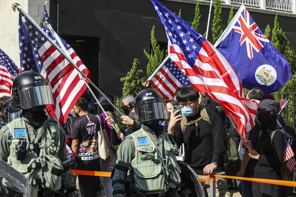 Anti-government protesters in Hong Kong wave US flags after the passage of the Hong Kong Human Rights and Democracy Act. Photo: May Tse
