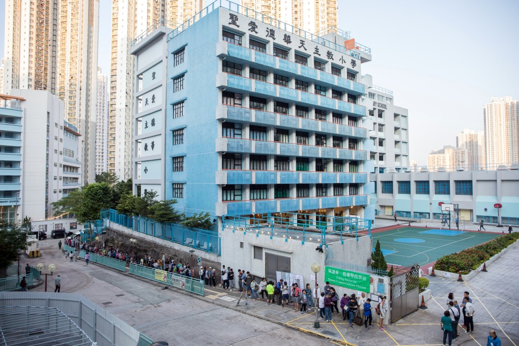 Voters stand in line in Lam Tin during the district council elections on November 24. Photo: Bloomberg