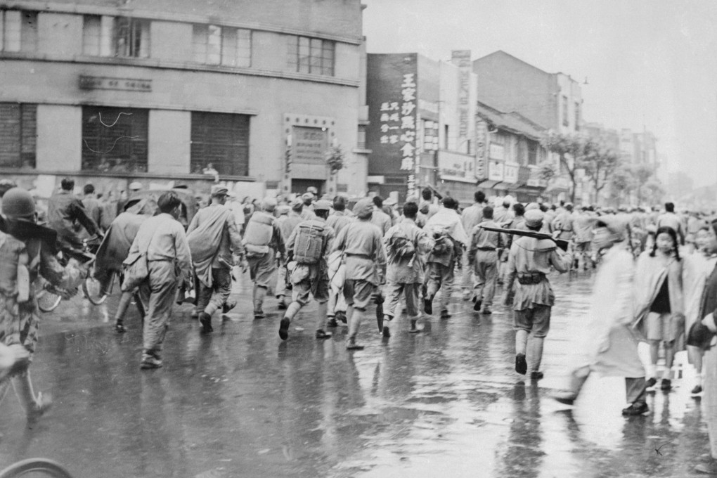 Disarmed Nationalist troops march down Nanking Road, the main street, under guard of Communist troops during the latter’s takeover of China. Photo: Getty Images