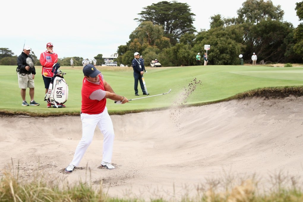 Patrick Reed was right where he didn’t want to be – in a greenside bunker – during the opening day of 2019 Presidents Cup action at Royal Melbourne Golf Club. Photo: EPA