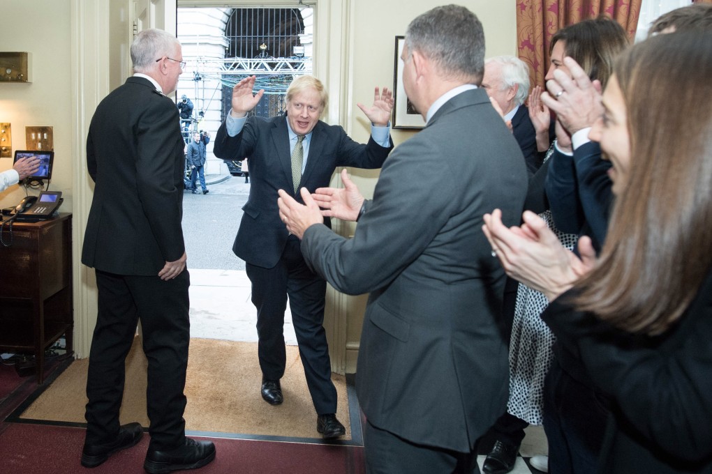 British Prime Minister Boris Johnson is greeted by staff as he arrives back at Downing Street. Photo: EPA-EFE