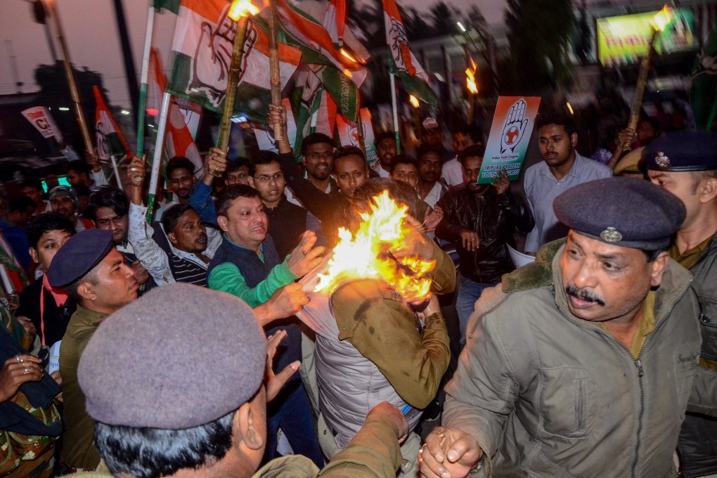 Police officers try to rescue a fellow officer who was set on fire during a protest against the Indian government's Citizenship Amendment Bill, in Agartala, the capital of India's northeastern state of Tripura. Photo: Agence France-Presse