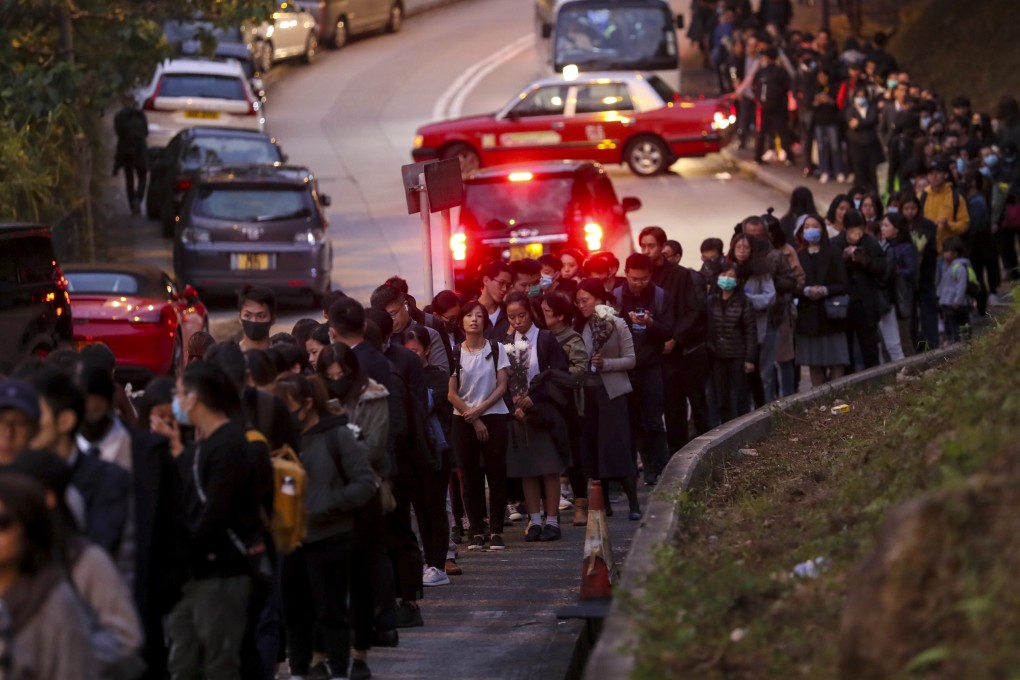 A long queue forms outside the memorial hall with people wanting to pay their respects to Chow Tsz-lok. Photo: Sam Tsang