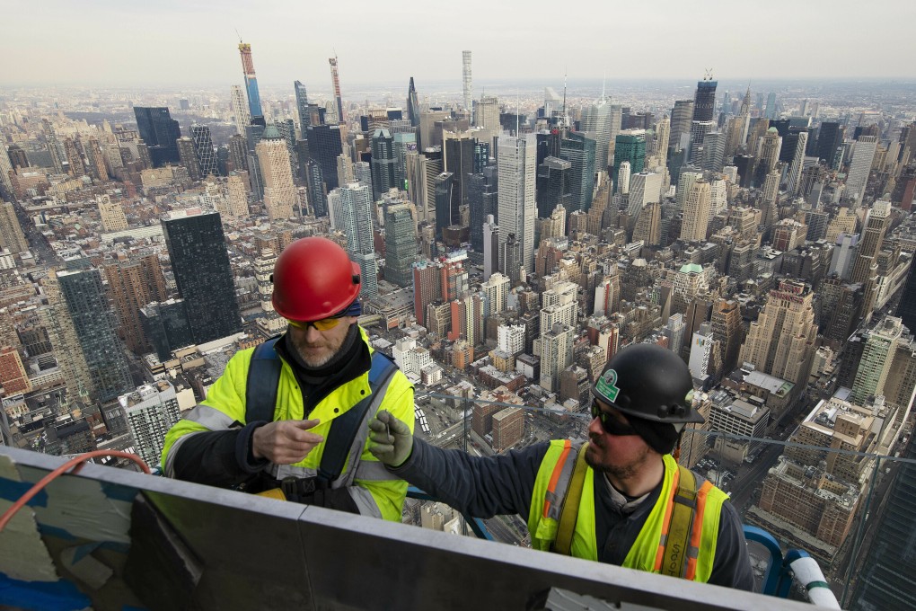 Work continues on an outdoor observation deck on an office building in New York. In the US, fears of a recession have fallen dramatically since the summer. Photo: AP