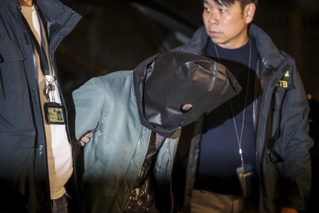 One of the suspects is brought to a Tuen Mun school as part of police investigations. Photo: Winson Wong