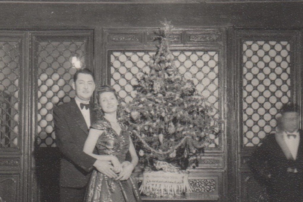 Roy Tchoo, an Anglo-Chinese cinema manager, and his Russian wife, Tatiana, a former dancer, attend a Christmas party in Peking in 1946.