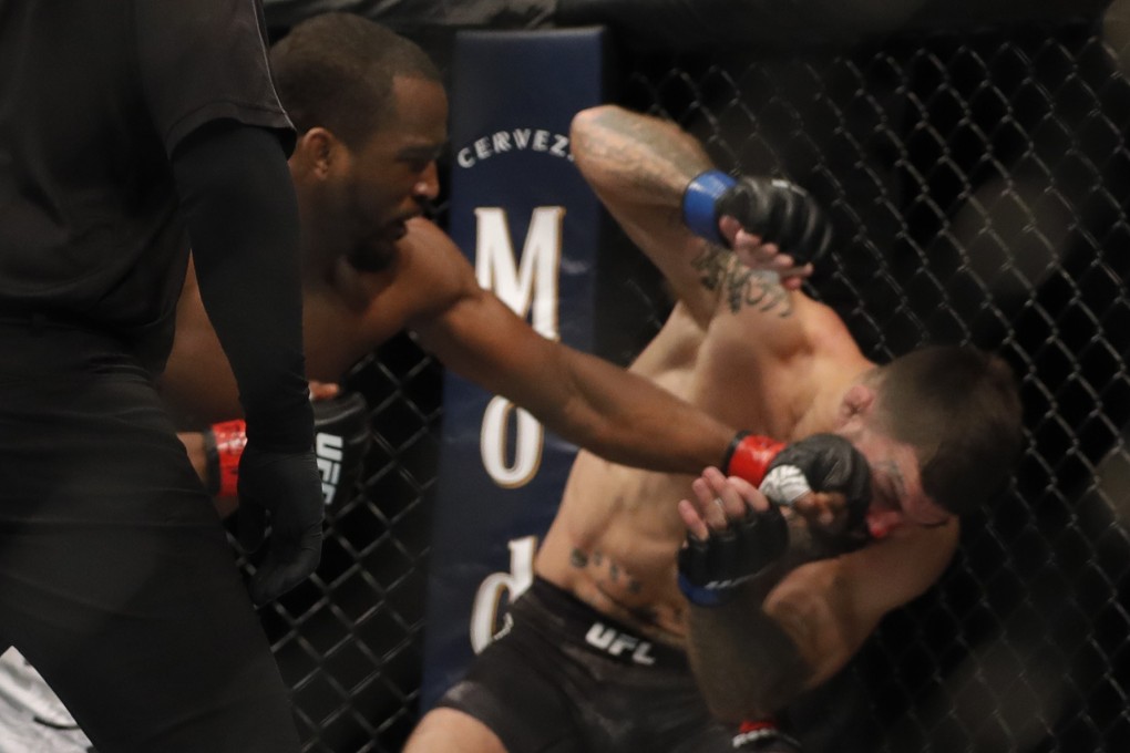 Geoff Neal lands a punch that sends Mike Perry to the canvas at UFC 245. Photo: AFP