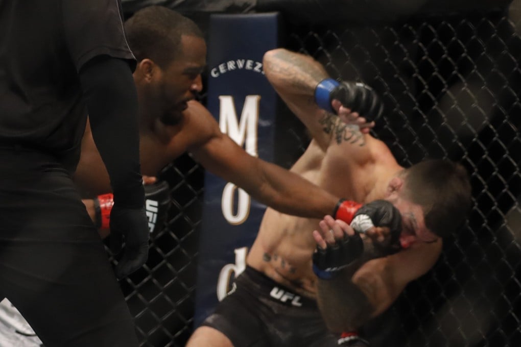 Geoff Neal lands a punch that sends Mike Perry to the canvas at UFC 245. Photo: AFP