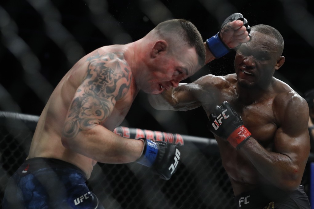 Colby Covington gets hit with a punch from UFC welterweight champion Kamaru Usman. Photo: AFP