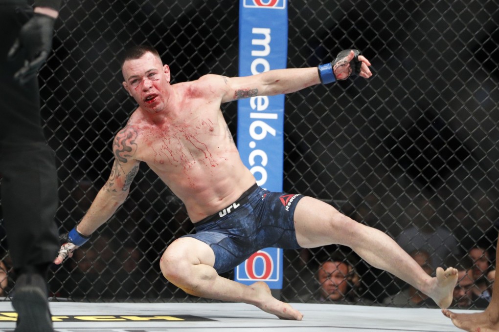 Colby Covington is knocked to the mat by Kamaru Usman at UFC 245. Photo: AP