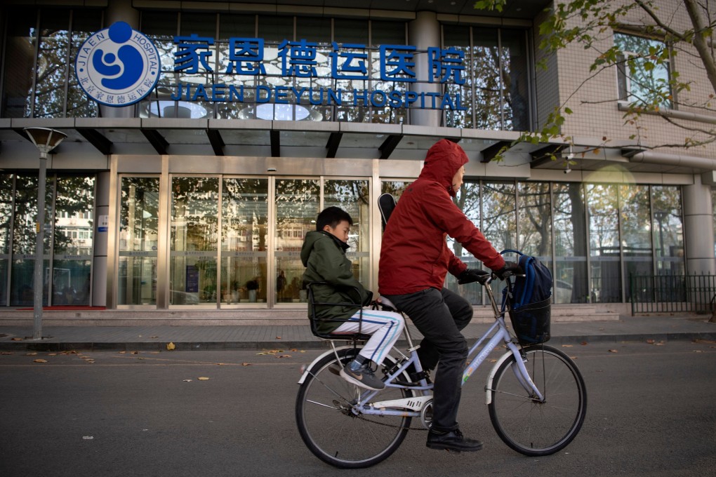 A boy rides pillion as a cyclist passes a fertility hospital in Beijing. Since single women in China have no access to local sperm banks, they tend to seek help from foreign ones. Given the choice, many would prefer a Caucasian sperm donor over a Chinese one. Photo: AFP