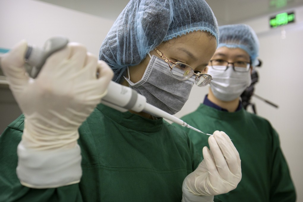 A researcher loads Cas9 protein and PCSK9 sgRNA molecules into a fine glass pipette in Shenzhen, China. Photo: AP