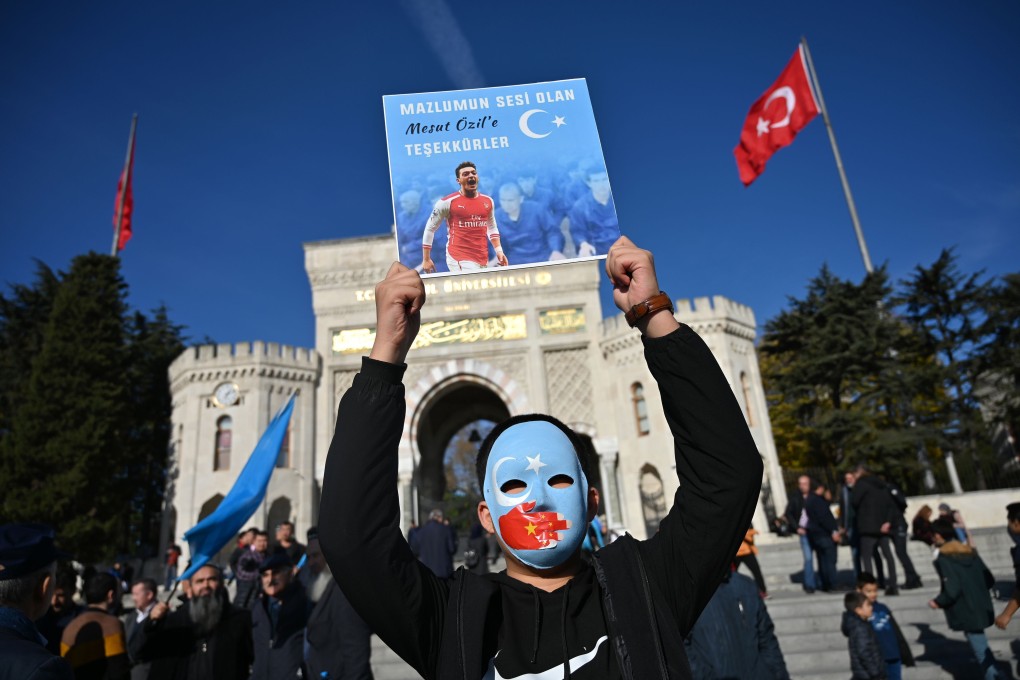 A supporter of China’s Muslim Uygur minority holds up a poster of Arsenal’s German midfielder Mesut Ozil with a message reading “Thanks for being our voice”, during a demonstration in Istanbul, Turkey, on December 14. Ozil, who is of Turkish origin, expressed support for Uygurs in Xinjiang and criticised Muslim countries for their failure to speak up for them. Photo: AFP