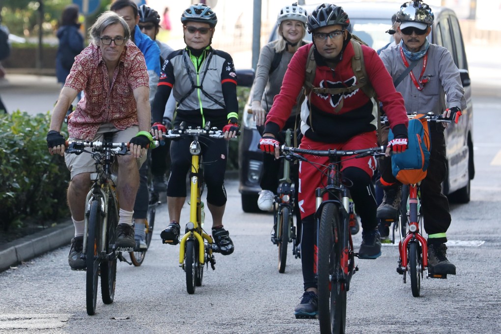 The “bike train” group cycle through Lai Chi Kok in Kowloon, Hong Kong, during their 15km bicycle commute from Tsim Sha Tsui to Tsuen Wan. A Hongkonger who founded a group to promote biking in London launched the initiative recently. Photo: Roy Issa