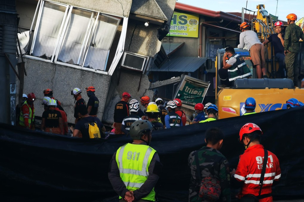 Rescuers search for survivors of a collapsed building after a 6.8-magnitude earthquake struck Padada town. Photo: AFP