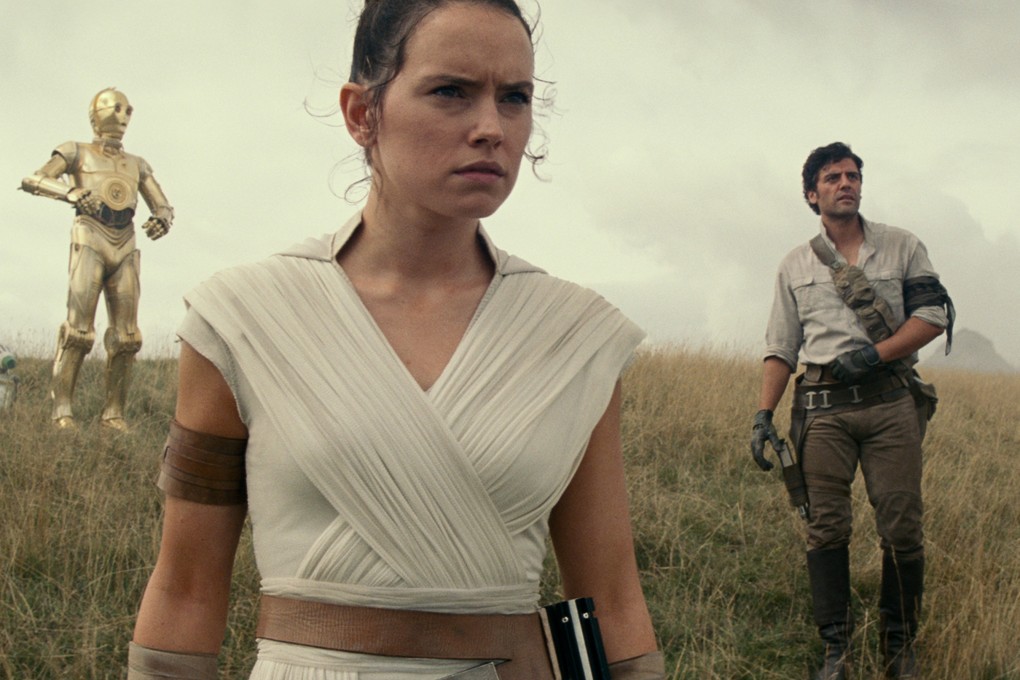 From left: D-O, Rey (Daisy Ridley), and Poe Dameron (Oscar Isaac) in a still from Star Wars: The Rise of Skywalker (category:), directed by J.J. Abrams. Adam Driver and John Boyega co-star.