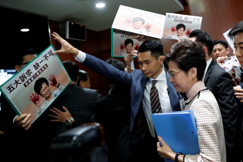 Opposition lawmakers raise protest slogans as Hong Kong Chief Executive Carrie Lam arrives at the Legislative Council on October 16 to present her annual policy address, which eventually had to be delivered via video. Photo: Reuters