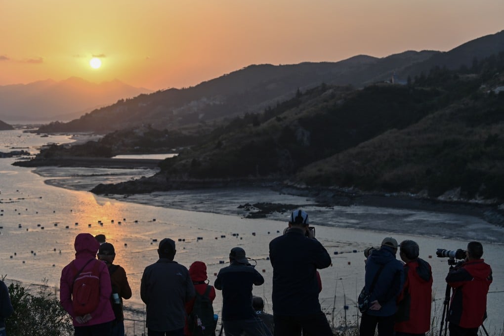 Chinese tourists taking photos of the sunset from Dong An Island in Xiapu in China’s Fujian province. Photo: AFP