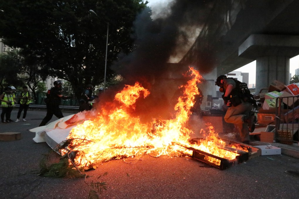 Anti-government protesters set rubbish on fire in the middle of the road in Tuen Mun on September 21. Photo: Felix Wong