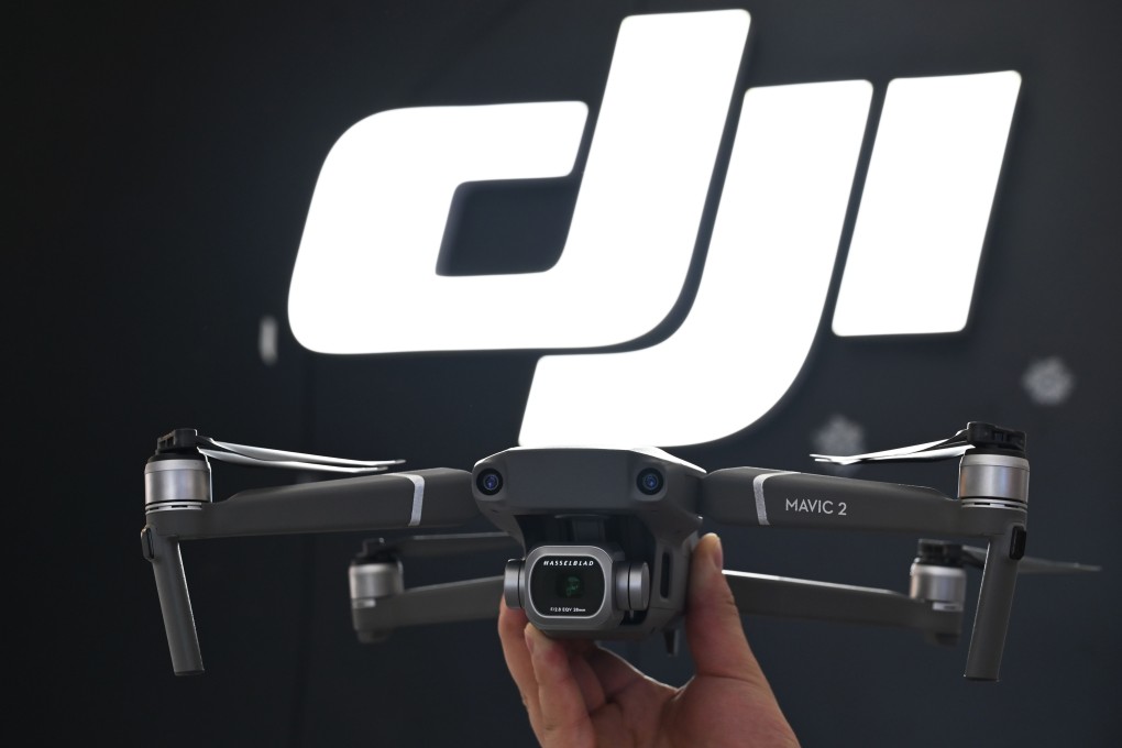An employee shows off a drone in a DJI store in Shanghai. Photo: AFP