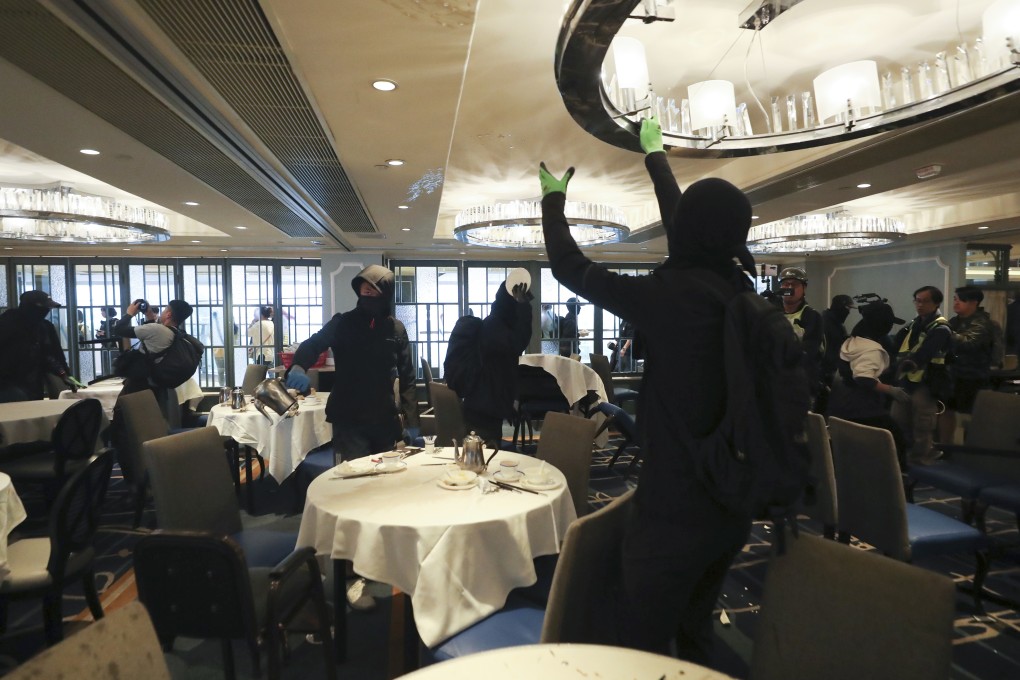 Masked protesters vandalise a Maxim’s restaurant in New Town Plaza in Sha Tin, as part of a series of “Christmas shopping” protests on December 15. Photo: Sam Tsang