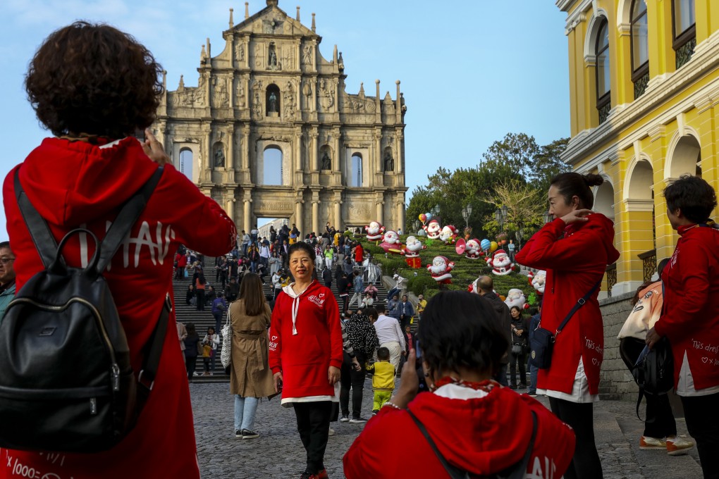 Tourists take photos at the Ruins of St Paul's in Macau on December 13. In addition to religion and culture, Portugal brought to its colony a continental European civil law system. Photo: Nora Tam