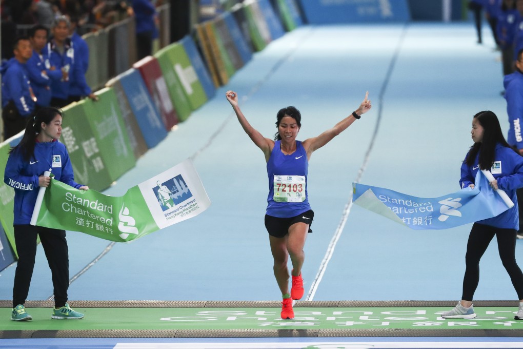 Christy Yiu kit-ching wins the women's half-marathon at the Standard Chartered Hong Kong Marathon. Photo: Nora Tam