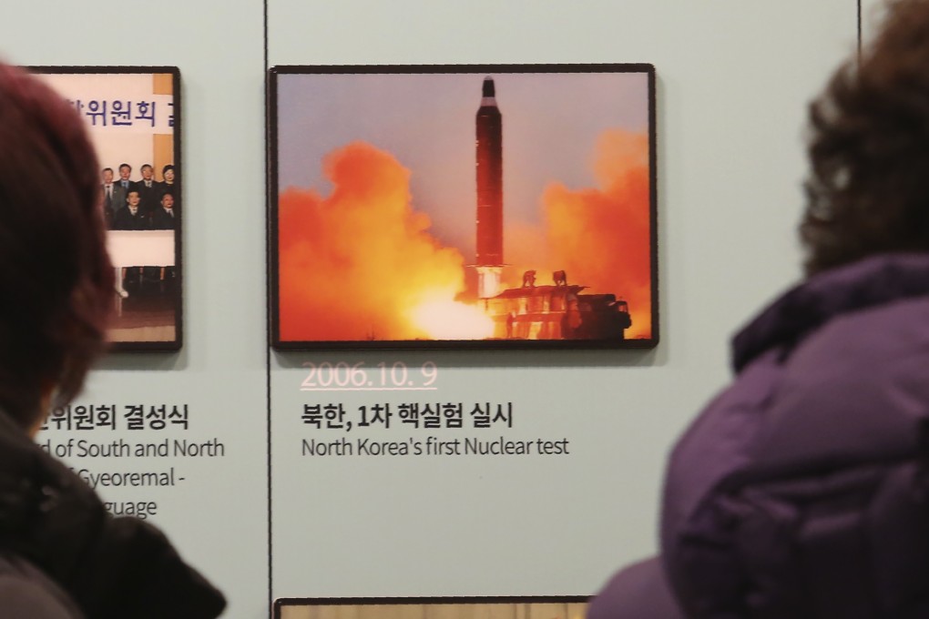 Visitors look at a photo of a North Korean missile launch at the Unification Observation Post in Paju, South Korea, on December 13. Photo: AP