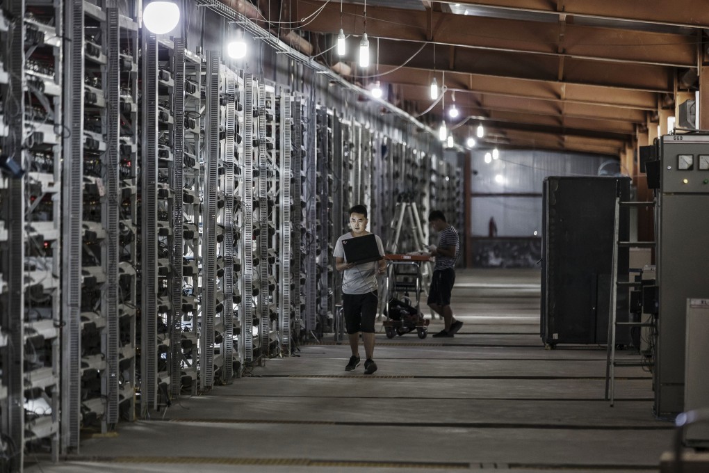 Technicians inspect bitcoin mining machines at a facility operated by Bitmain Technologies in Ordos, Inner Mongolia, China. Photo: Bloomberg
