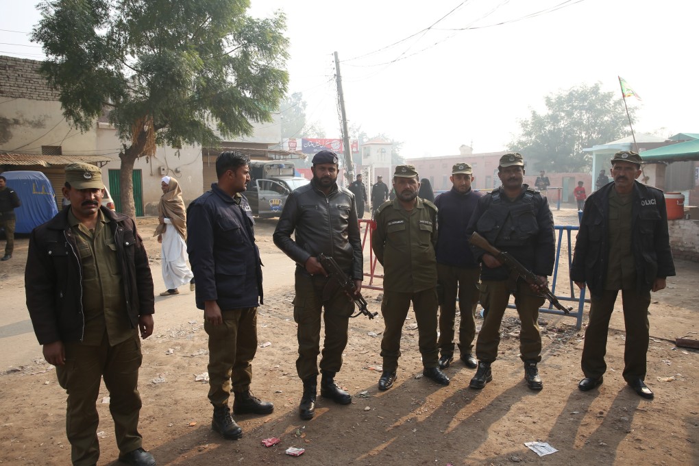 Pakistani police officers stand guard outside a Multan jail after the court’s decision. Photo: AP