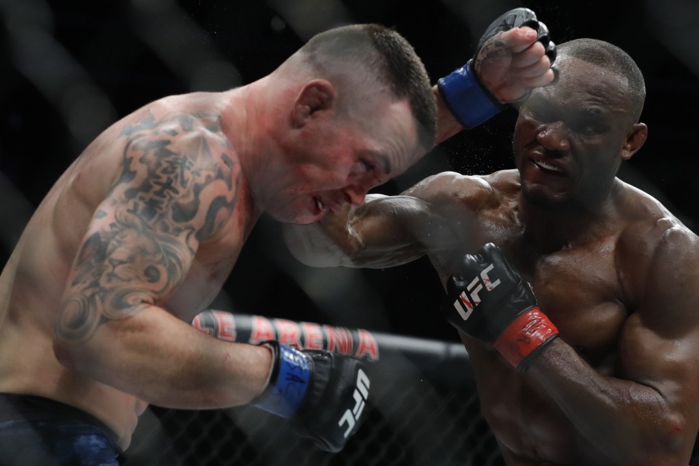 Colby Covington gets hit with a punch from UFC welterweight champion Kamaru Usman. Photo: AFP