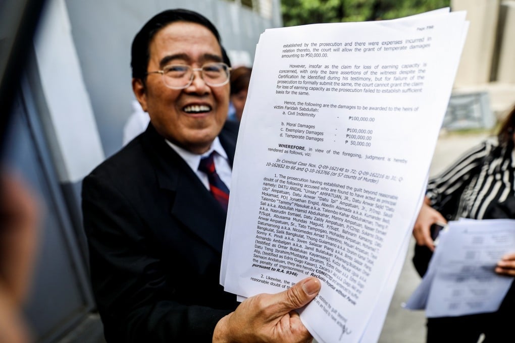A lawyer for the family of one of the victims shows the page of Judge Jocelyn Solis-Reyes’ decision proclaiming a guilty verdict. Photo: Reuters