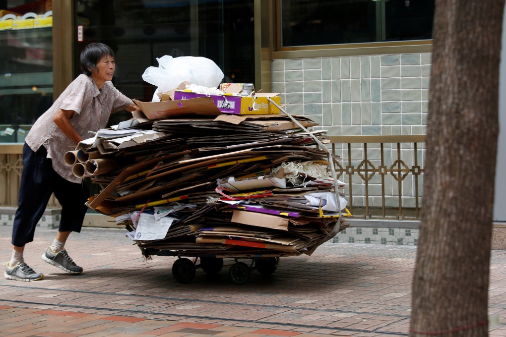 An elderly woman collects cardboard on a street in Hong Kong. A local company has committed HK$2.7 million to subsidise the recycling industry. Photo: Bobby Yip