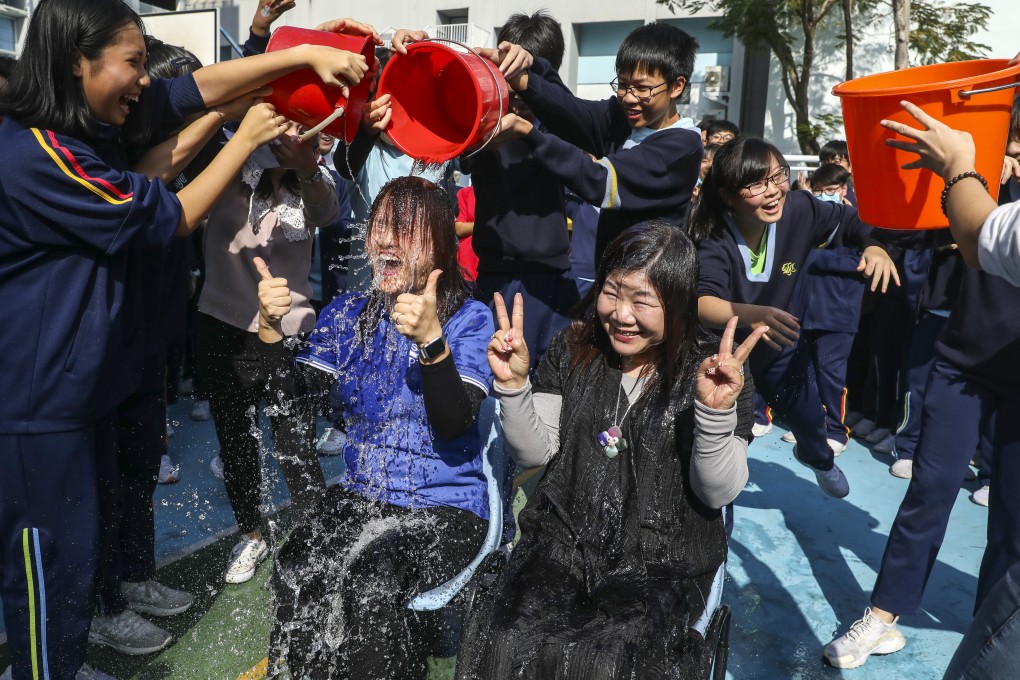 Vice-principal Chan Wai-wa (left) and principal Cecilia Tang get drenched. Photo: Dickson Lee