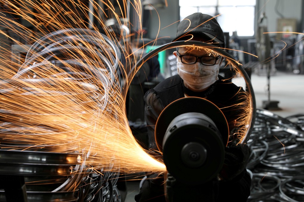 A worker polishes a bicycle steel rim at a factory manufacturing sports equipment in Hangzhou, Zhejiang province, China. Photo: Reuters
