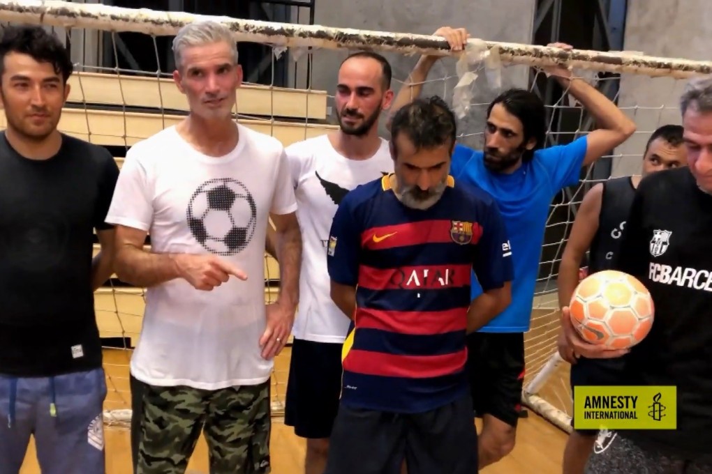 Craig Foster with refugees after arranging an indoor football match in Port Moresby. Photo: Amnesty International