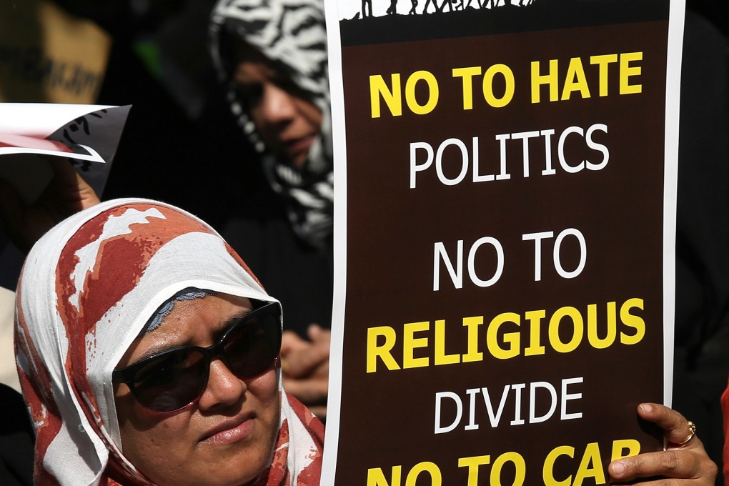 A demonstrator at a rally shows solidarity with university students in New Delhi arrested or beaten up by police for protesting against the Citizenship Amendment Act and National Register of Citizens, in the southern Indian city of Bangalore on December 23. The act will give Indian citizenship rights to Hindu, Jain, Buddhist, Sikh, Parsee or Christian migrants from Afghanistan, Bangladesh and Pakistan. Photo: EPA-EFE