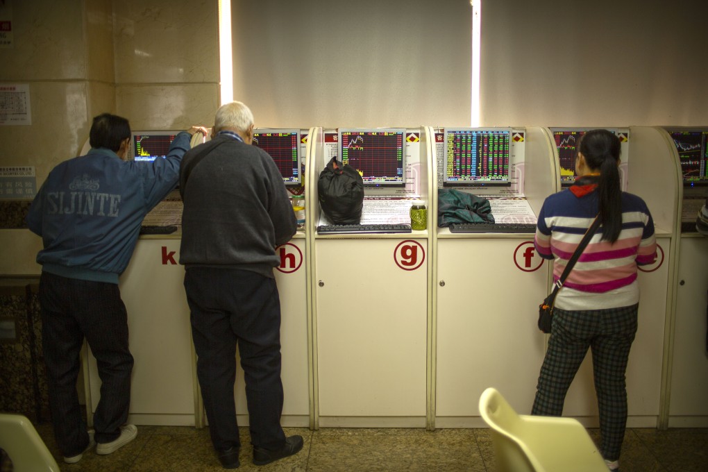 Chinese investors monitor stock prices at a brokerage house in Bejiing. Photo: AP Photo