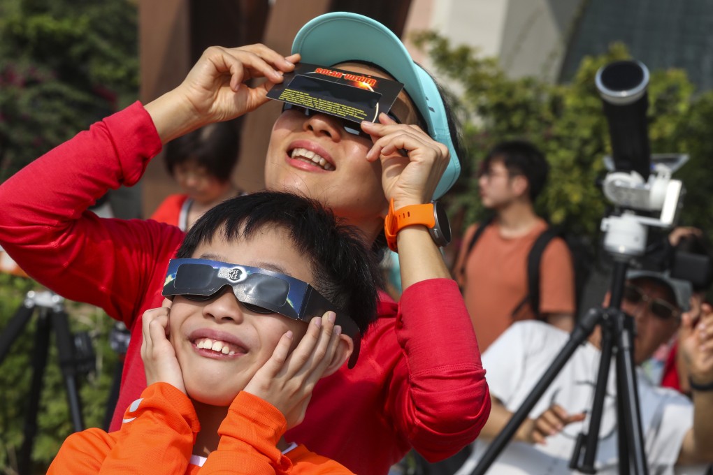 People in Hong Kong gathered at the city’s space museum to watch a partial solar eclipse on Boxing Day. Photo: Felix Wong