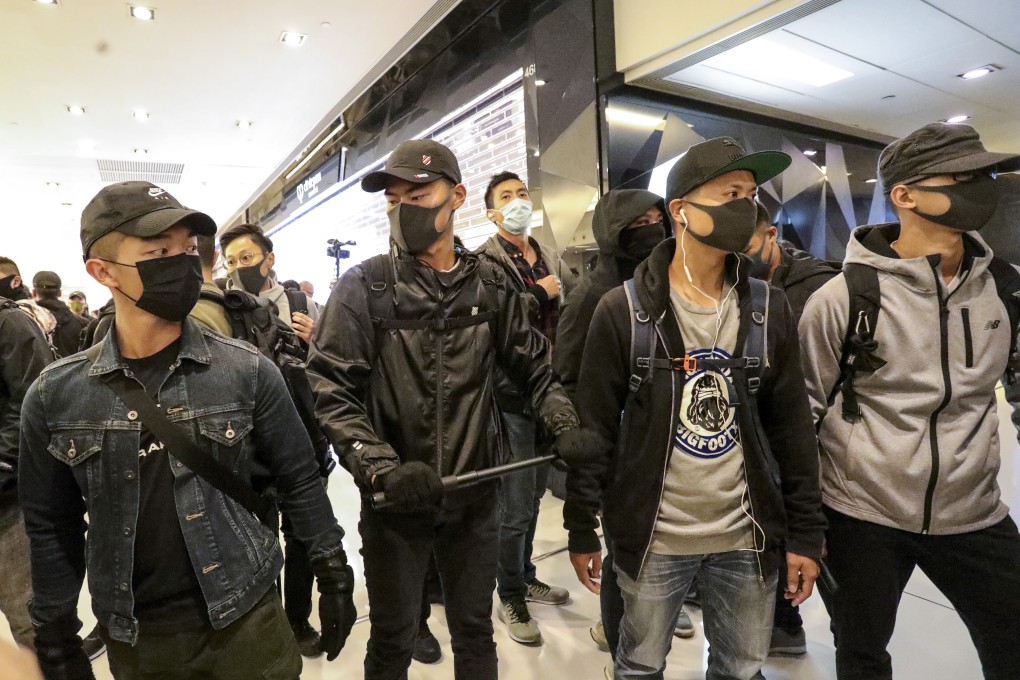Plain-clothes police officers stand guard in a shopping mall in Sha Tin on Christmas Day. Photo: May Tse