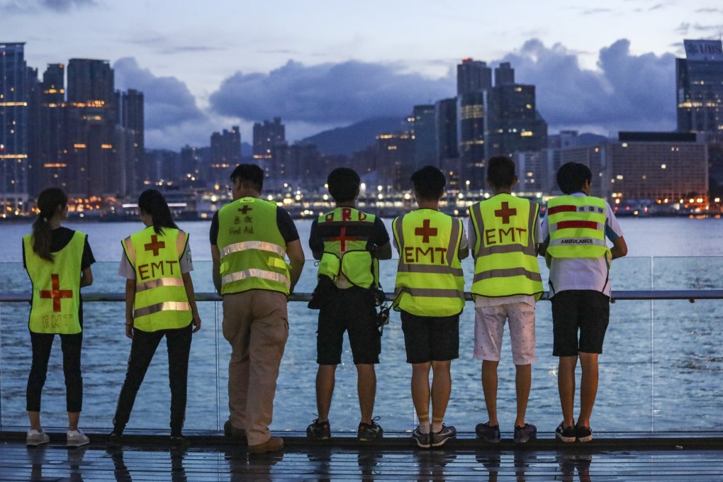 Volunteer first-aid workers look out across Victoria Harbour in Tamar, Admiralty, during a protest against the Hong Kong government’s extradition bill on June 18. As they fight for a better future, Hong Kong’s anti-government protesters should broaden their scope to encompass climate change. Photo: Dickson Lee