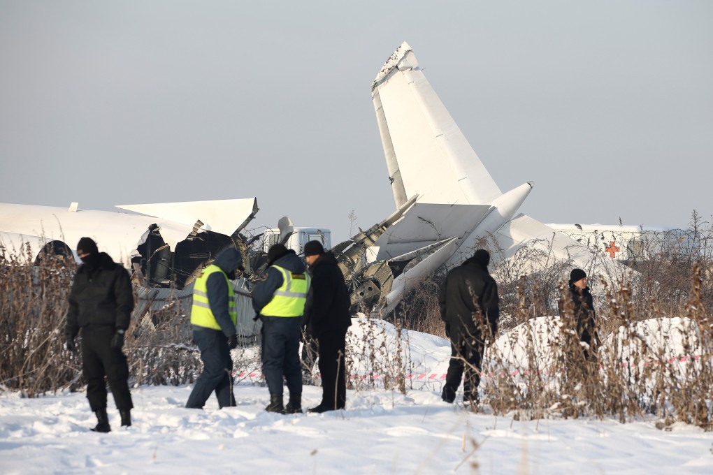 Emergency and security personnel at the site of a plane crash near Almaty, Kazakhstan. Photo: Reuters