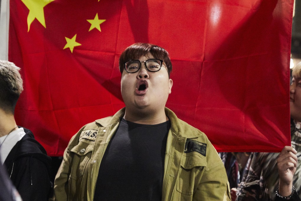 A pro-China counter-protester sings the country’s national anthem during a rally on August 16 at the State Library in Melbourne, Australia. Photo: EPA-EFE
