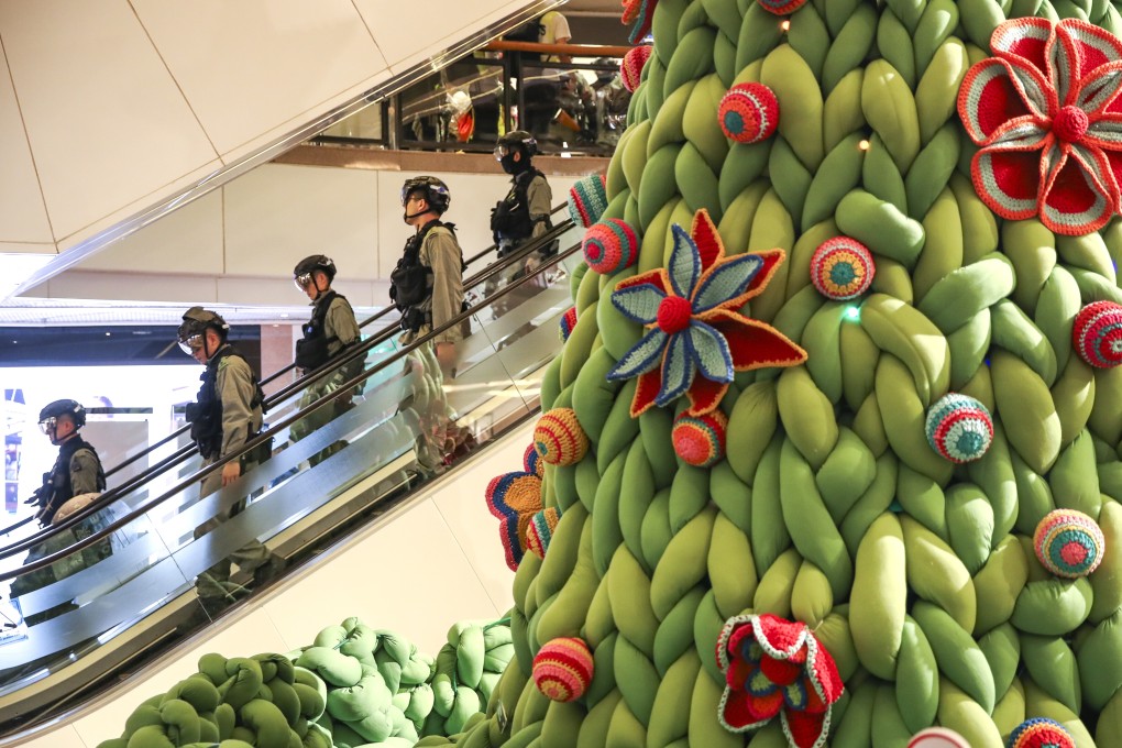 Riot police stand by as anti-government protesters hold a “Christmas shopping rally” at the Harbour City shopping mall in Tsim Sha Tsui on December 21. Photo: Winson Wong