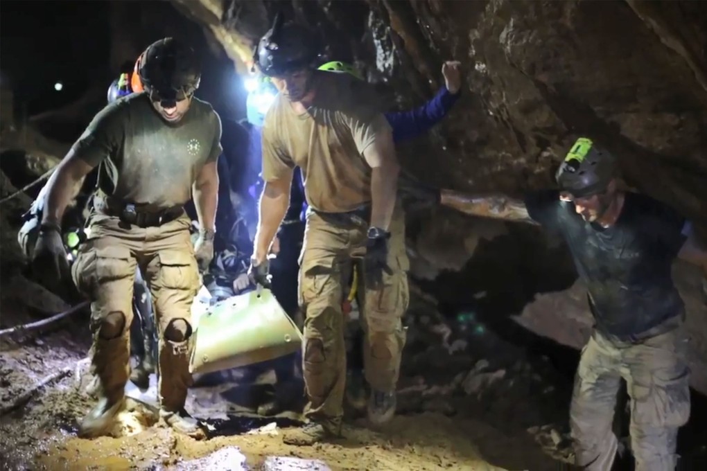 Royal Thai Navy footage shows rescue personnel carrying a member of the Wild Boars soccer team on a stretcher during the rescue operation inside the Tham Luang cave last year. Photo: Thai Royal Navy via AFP