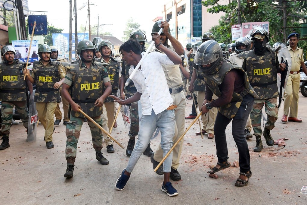 Police with sticks locally known as ‘lathi’ beat a protester during a demonstration against India's new citizenship law in Mangalore. Photo: AFP
