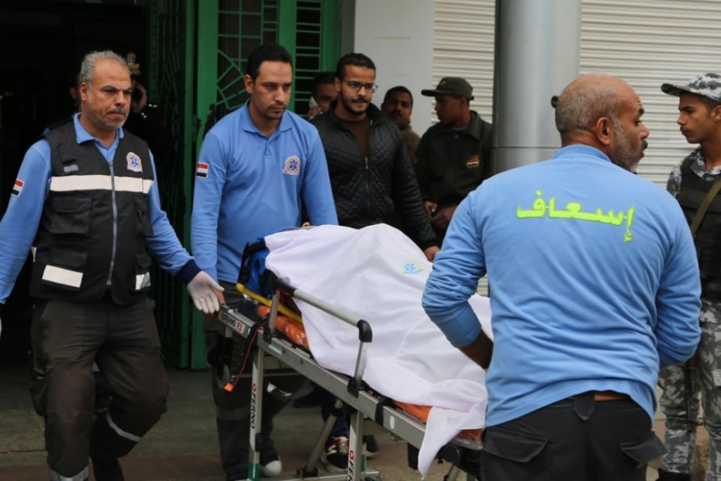 Paramedics transport people who were injured in a collision between a tourist bus and a public bus in Egypt. Photo: DPA