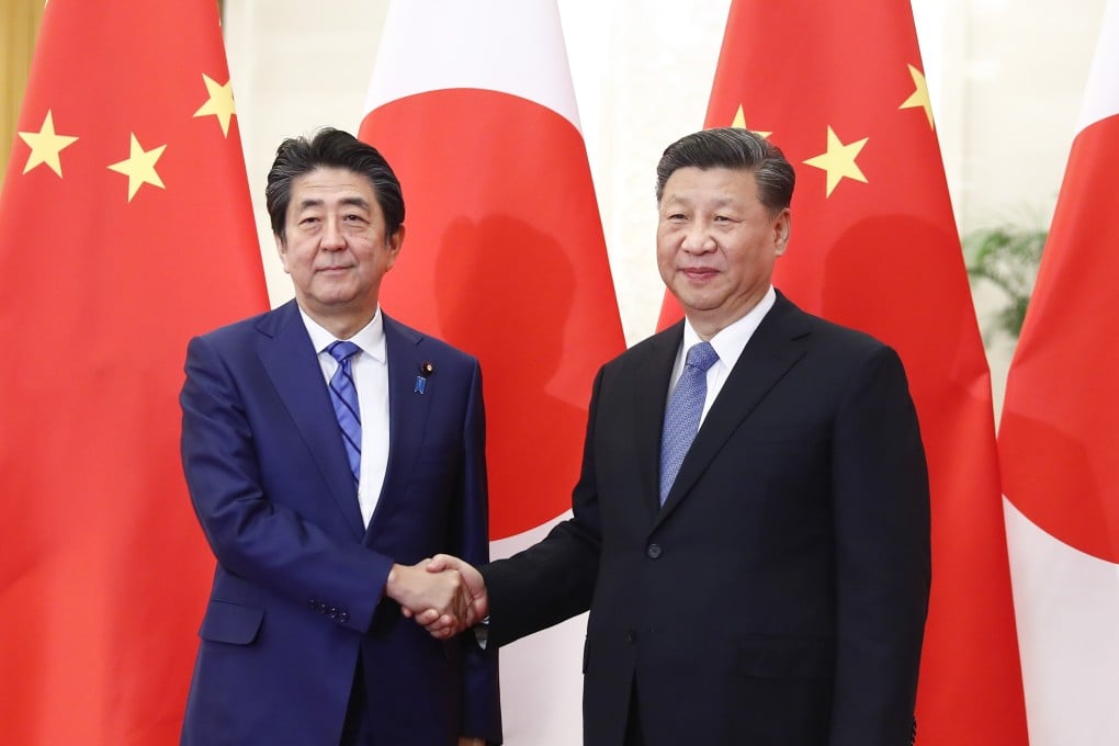 Japanese Prime Minister Shinzo Abe shakes hand with Chinese President Xi Jinping. Xi’s planned spring visit to Japan provides an opportunity to contain mutual hostility and expand relations. Photo: DPA