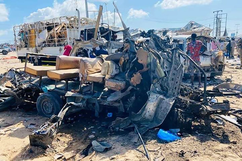The wreckage of bus after a car bomb exploded at a security checkpoint in Mogadishu, killing more than 70 people. Photo: DPA